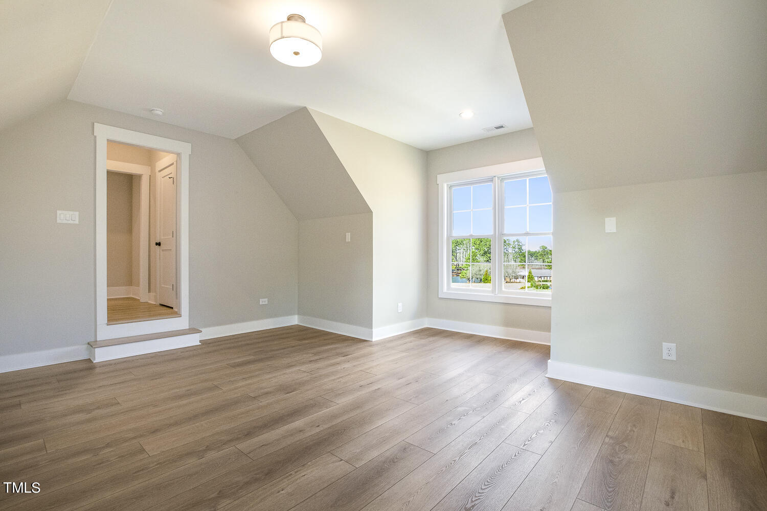 593 Pope Lake Road Angier, NC 27501 - Photo 44 of 48 a view of an empty room with wooden floor and a window