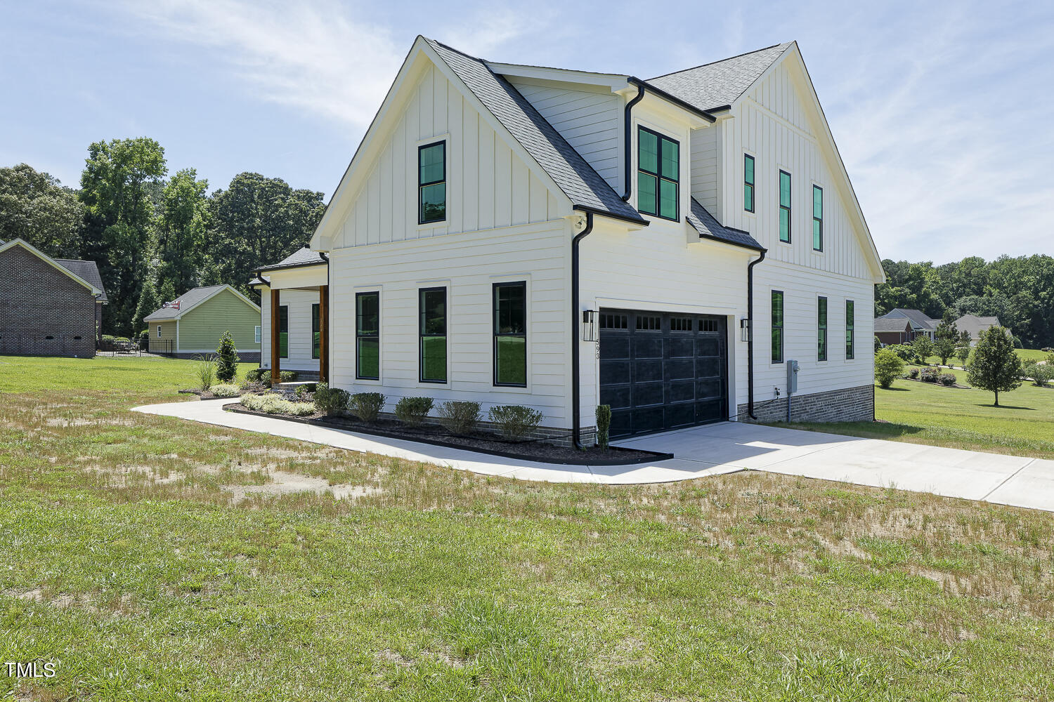 593 Pope Lake Road Angier, NC 27501 - Photo 5 of 48 a view of a white house with a yard and plants