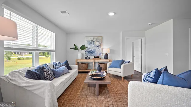 a living room with furniture and a large window