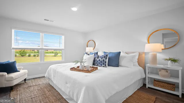 a bedroom with a bed a table and chair