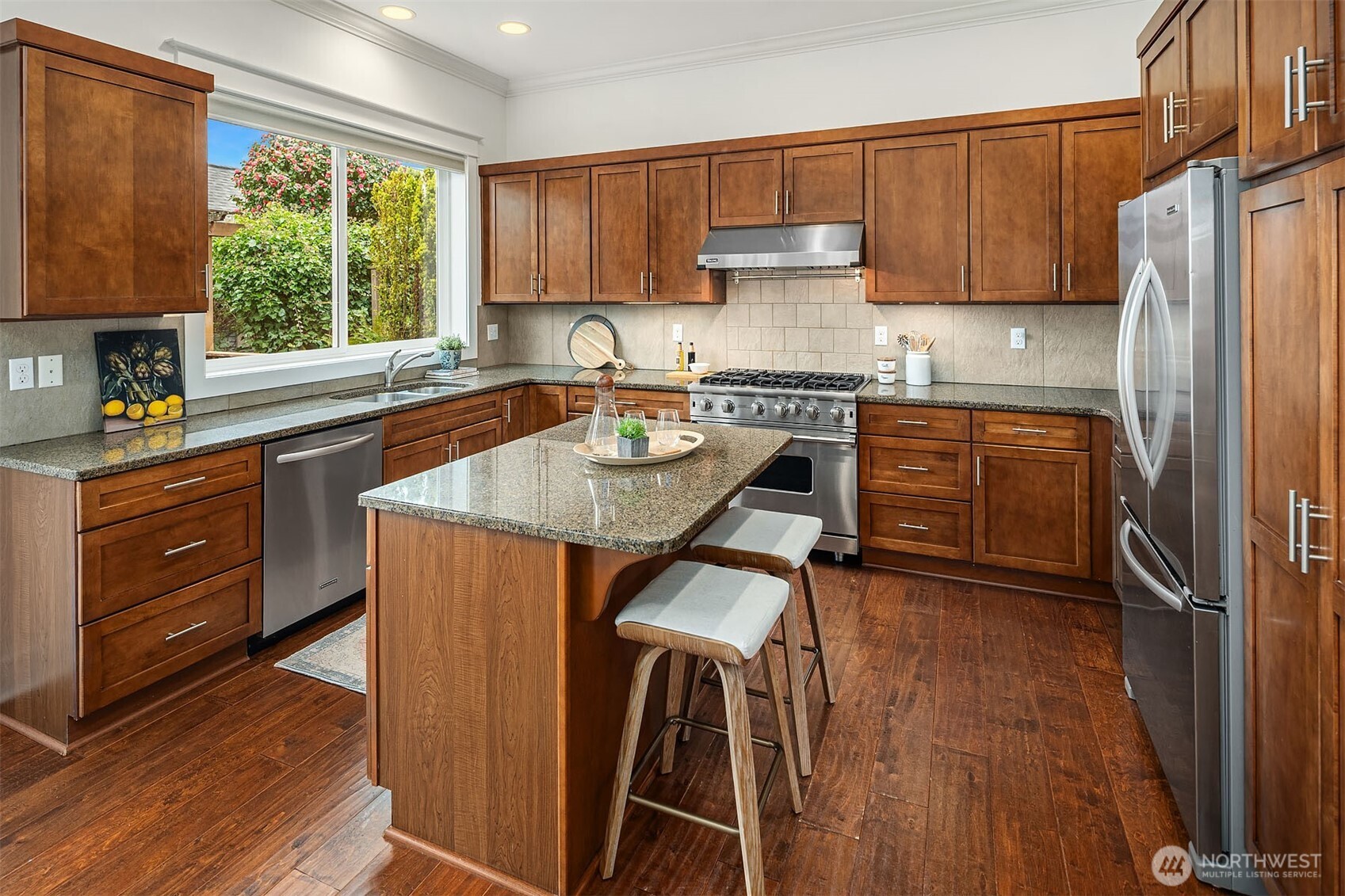 1520 37th Avenue Seattle, WA 98122 - Photo 11 of 35 a kitchen with stainless steel appliances granite countertop a refrigerator a sink dishwasher a stove and white countertops with wooden floor