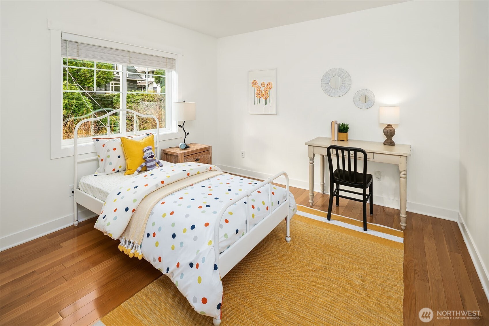 1520 37th Avenue Seattle, WA 98122 - Photo 30 of 35 a bedroom with a bed a stove and a window