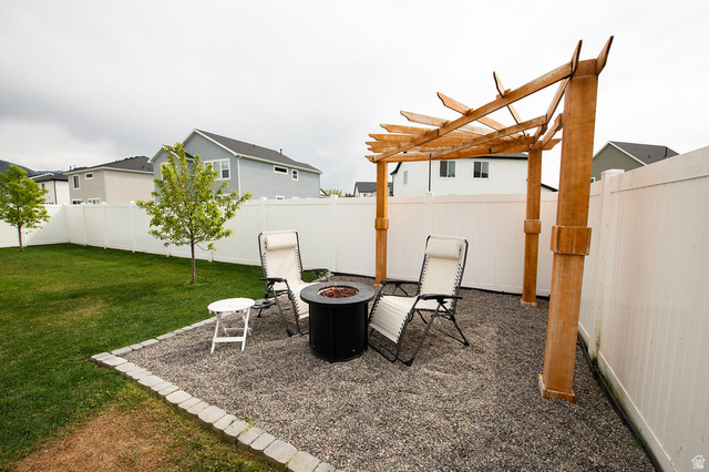 384 Ropelato Drive Nibley, UT 84321 - Photo 21 of 25 Fenced backyard with a patio and a fire pit