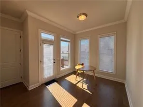 a view of a hallway with wooden floor and entryway