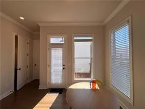 an empty room with windows and entrance