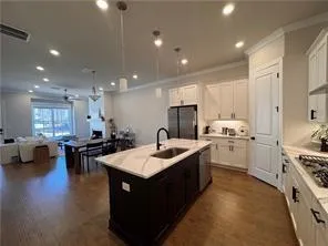a kitchen with sink stove and chairs