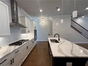 a kitchen with a sink a stove a refrigerator and cabinets