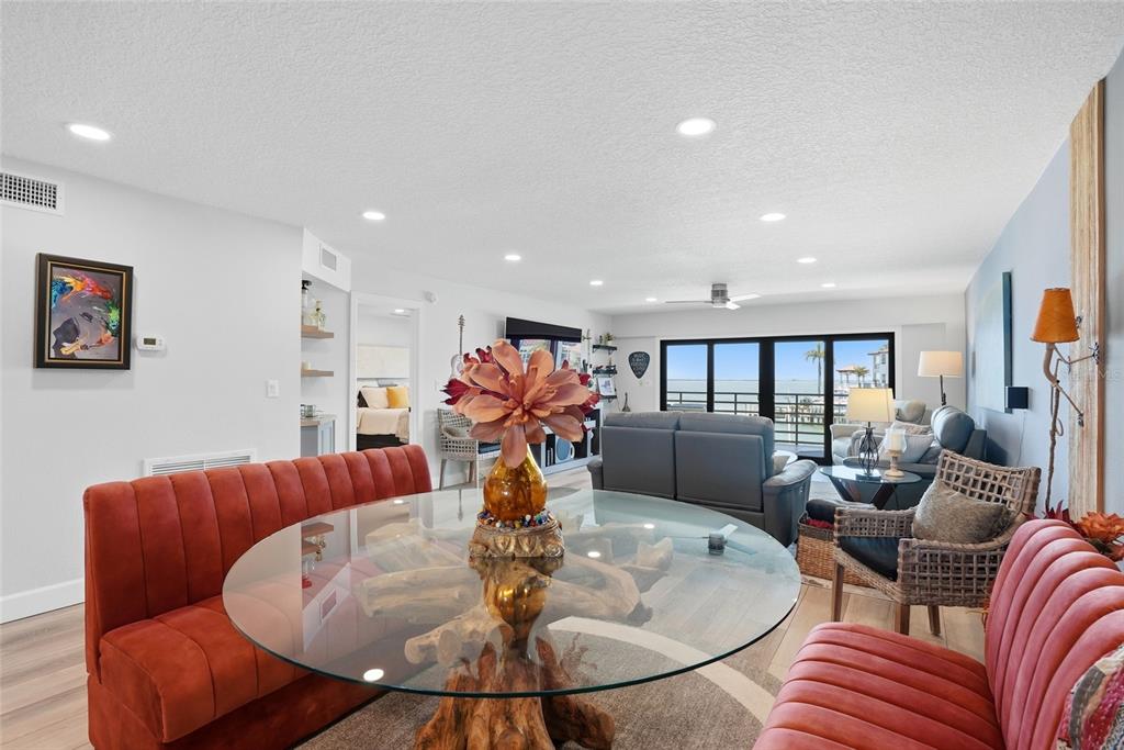 363 Pinellas Bayway South, Unit 29 Tierra Verde, FL 33715 - Photo 15 of 59 a living room with furniture a chandelier and a dining table
