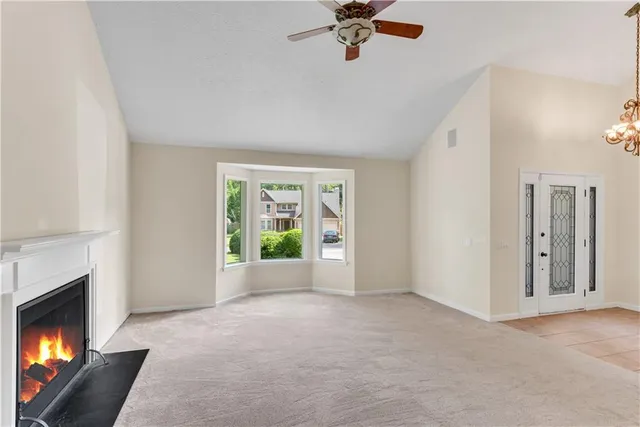 a view of an empty room with a fireplace