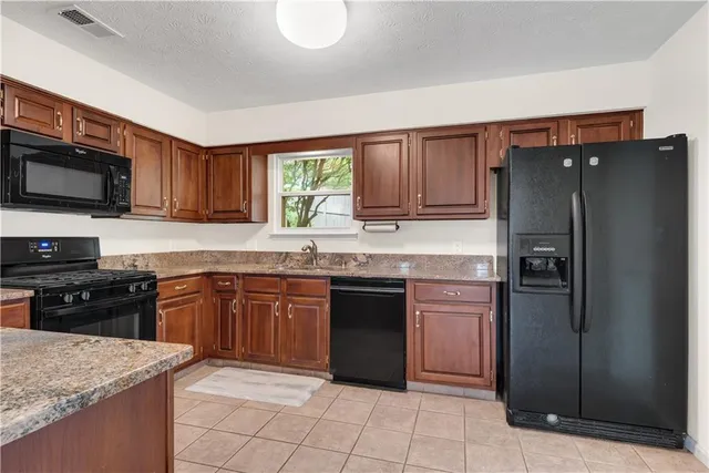 a kitchen with stainless steel appliances a refrigerator and a stove