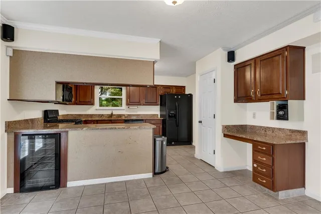 a kitchen with stainless steel appliances a refrigerator sink and microwave