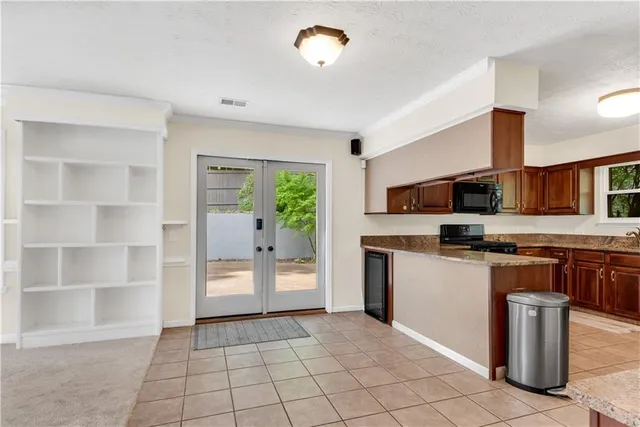 a view of an empty room with a fireplace and a window