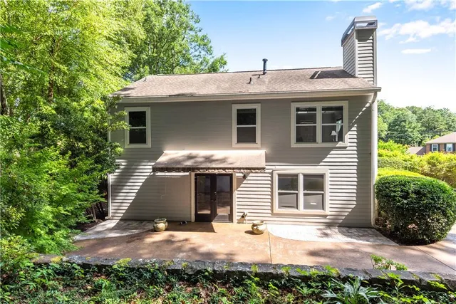 a view of a hallway with wooden shelves