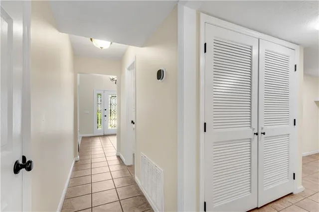 a spacious bedroom with a bed and a potted plant