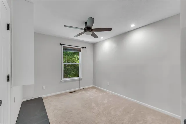 a view of a house with a big yard and large trees