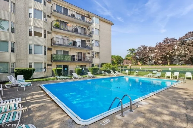 a view of swimming pool with outdoor seating and plants