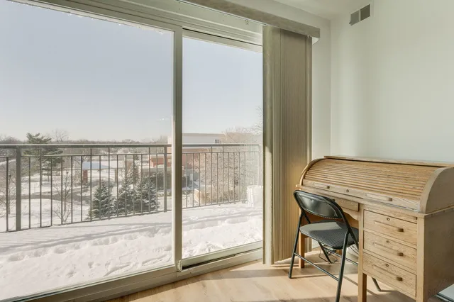 a view of a room that has a bed and a view of balcony