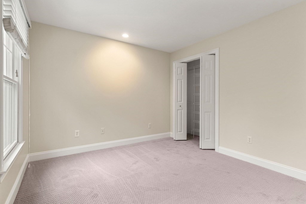 11 Meadowbrook Road, Unit 11 Brookline, MA 02467 - Photo 16 of 42 an empty room with an entryway and window