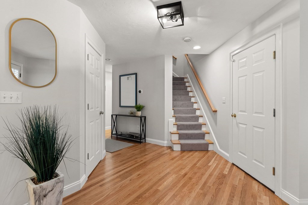 11 Meadowbrook Road, Unit 11 Brookline, MA 02467 - Photo 2 of 42 a view of a livingroom with wooden floor and a staircase