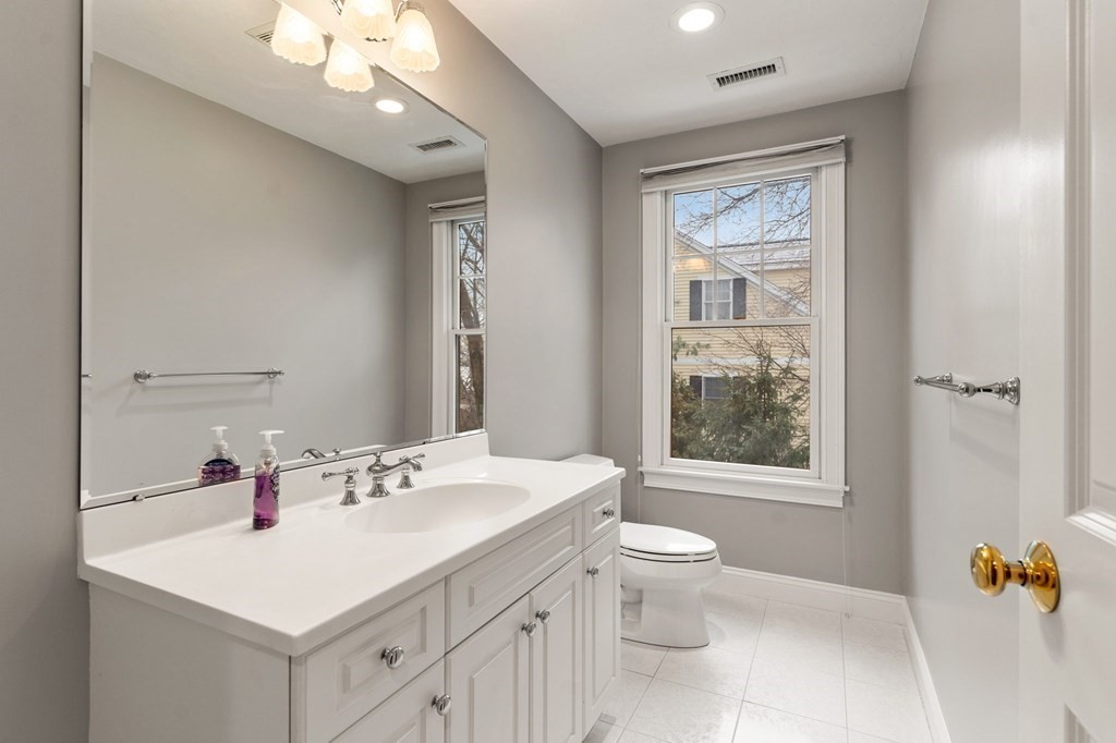 11 Meadowbrook Road, Unit 11 Brookline, MA 02467 - Photo 30 of 42 a bathroom with a sink a toilet and a mirror