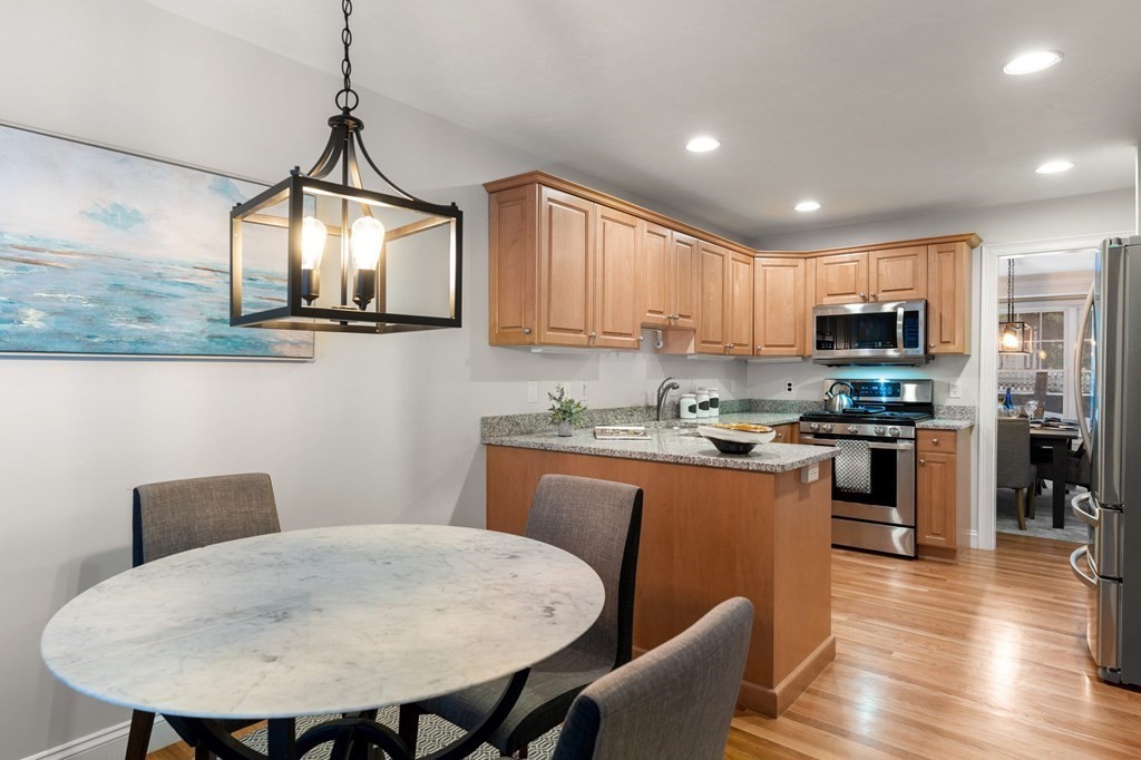 11 Meadowbrook Road, Unit 11 Brookline, MA 02467 - Photo 5 of 42 a kitchen with stainless steel appliances granite countertop a sink a microwave refrigerator and a stove