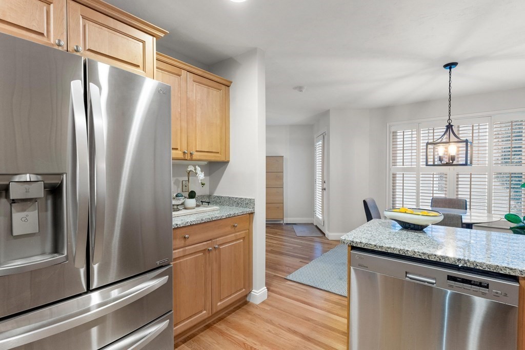 11 Meadowbrook Road, Unit 11 Brookline, MA 02467 - Photo 7 of 42 a kitchen with granite countertop a refrigerator and a sink