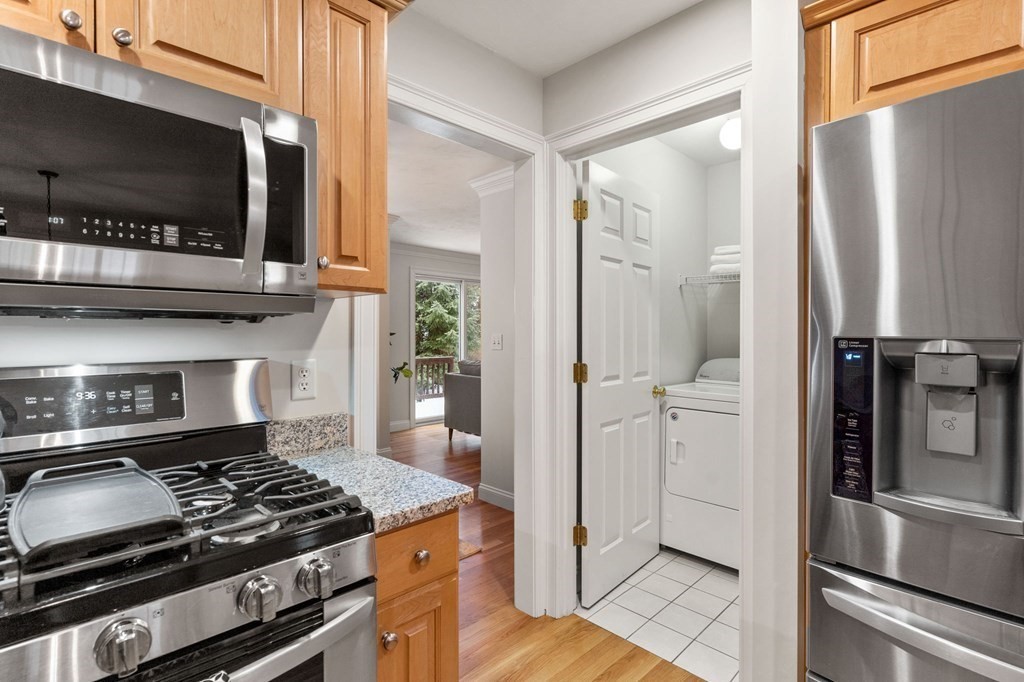 11 Meadowbrook Road, Unit 11 Brookline, MA 02467 - Photo 9 of 42 a kitchen with stainless steel appliances granite countertop a refrigerator and a stove top oven