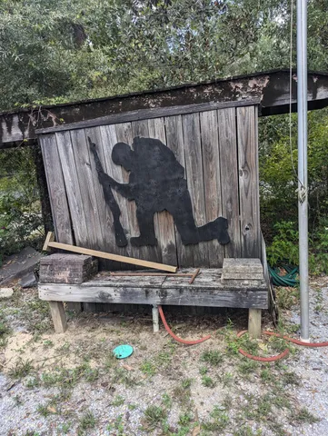 a wooden bench sitting in a back yard