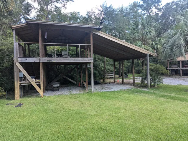 a view of house with backyard and deck