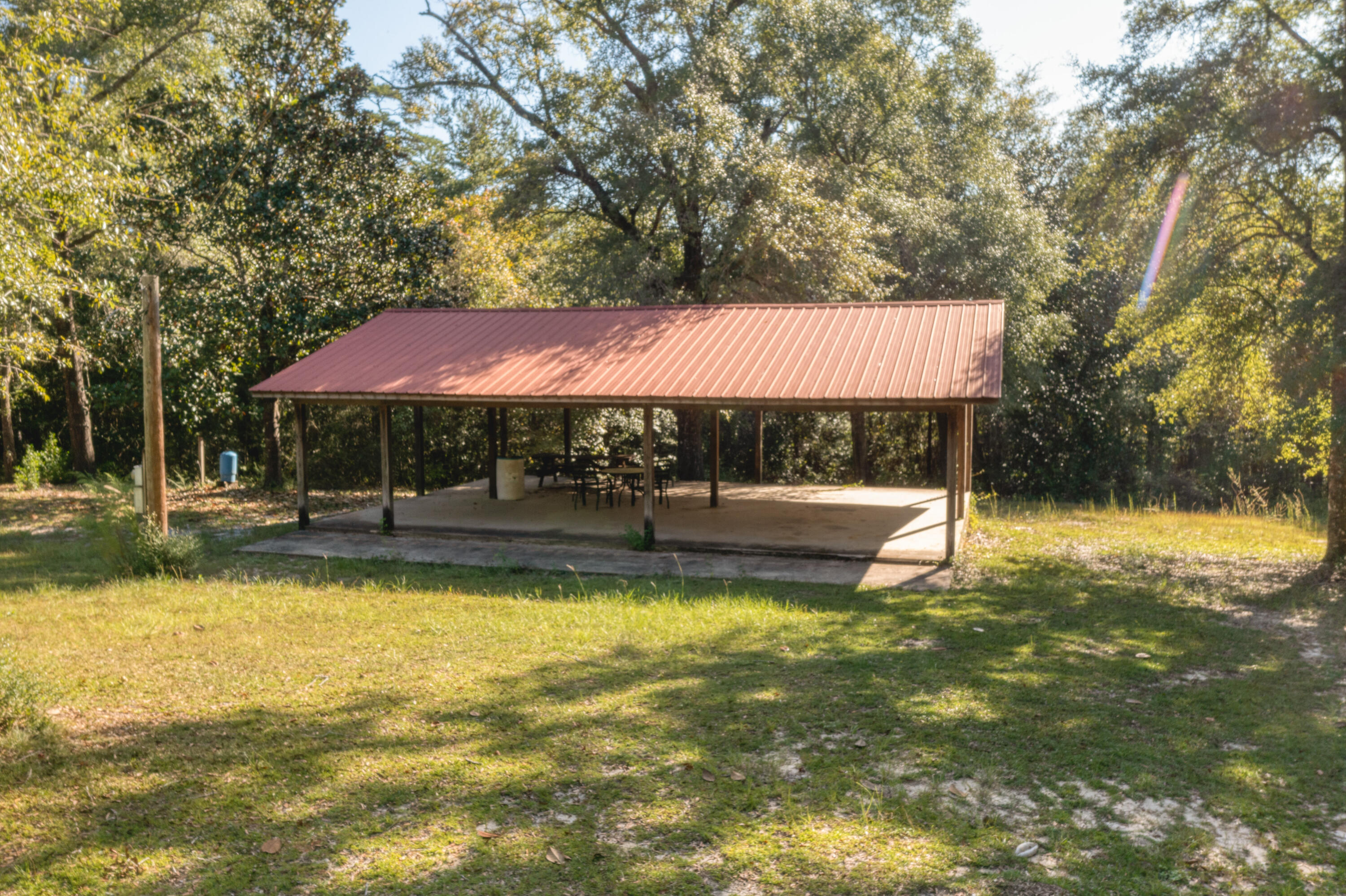 4964 Retreat Inlet Baker, FL 32531 - Photo 23 of 28 a view of swimming pool and table and chairs under an umbrella