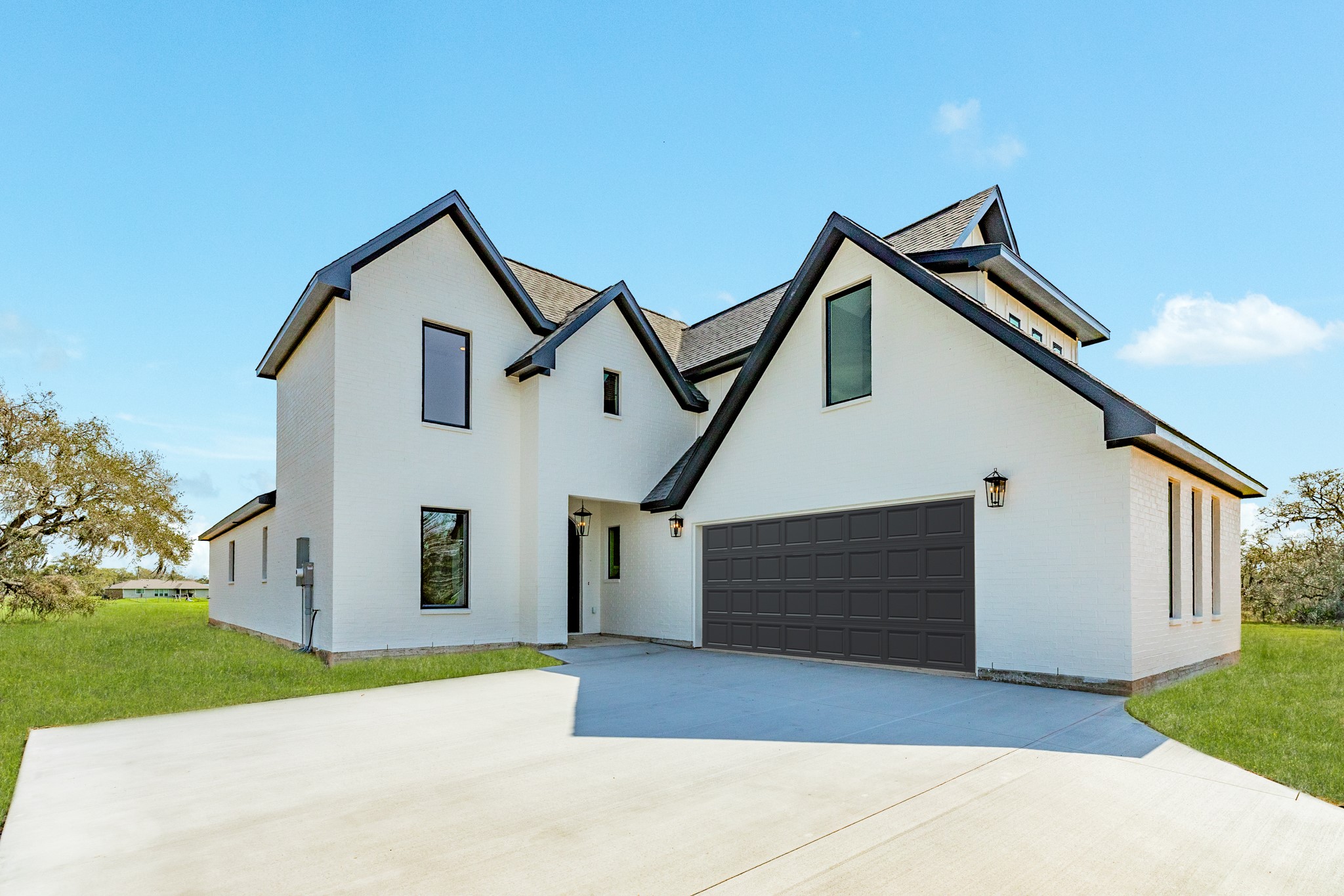 1737 Flintlock Court Angleton, TX 77515 - Photo 2 of 47 The elevation of this home offers a stunning view as you pull into the drive way. Boasting black windows, white painted brick exterior, and a spacious drive way.