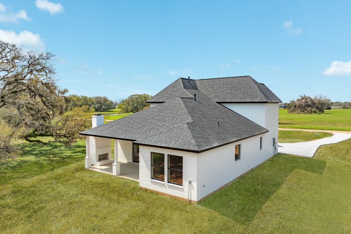 1737 Flintlock Court Angleton, TX 77515 - Photo 7 of 47 The back setting of this home offers a covered patio with an out door fireplace perfect for relaxing and enjoying the peace and tranquillity this property offers. Sliding back doors that allow the indoor living room and out door patio to become an indoor/outdoor living expierence.