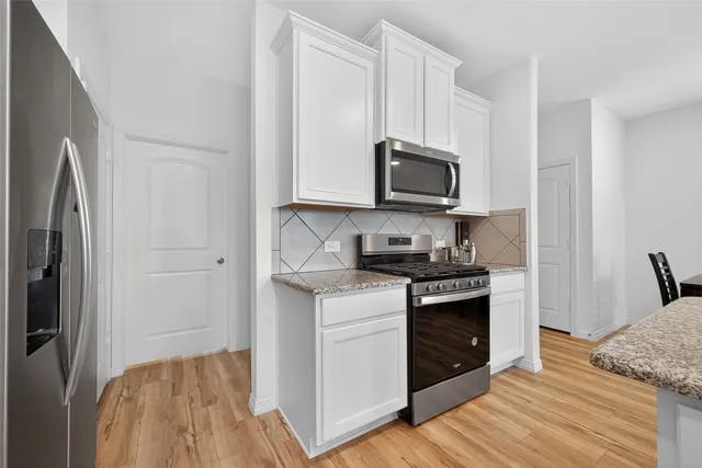 a kitchen with a stove and a microwave