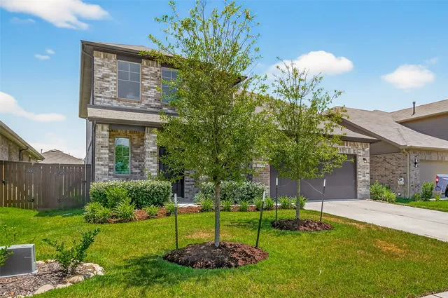 a view of a house with a yard and a garden