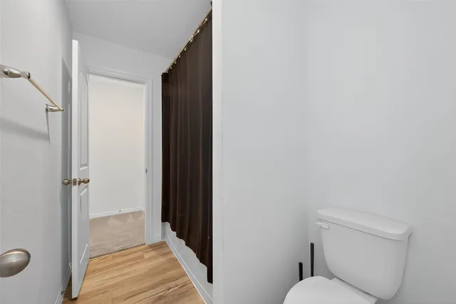 a bathroom with a toilet and a shower