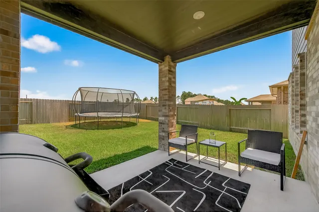 a backyard of a house with outdoor seating