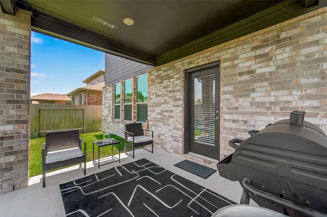 a view of a house with a backyard porch and sitting area
