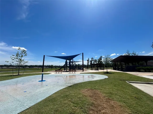 a view of a backyard with swimming pool