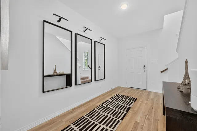 a view of a room with wooden floor