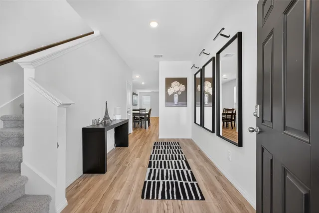 a view of a hallway view with wooden floor and staircase