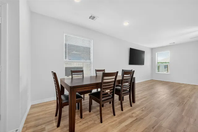a view of a dining room with furniture and wooden floor