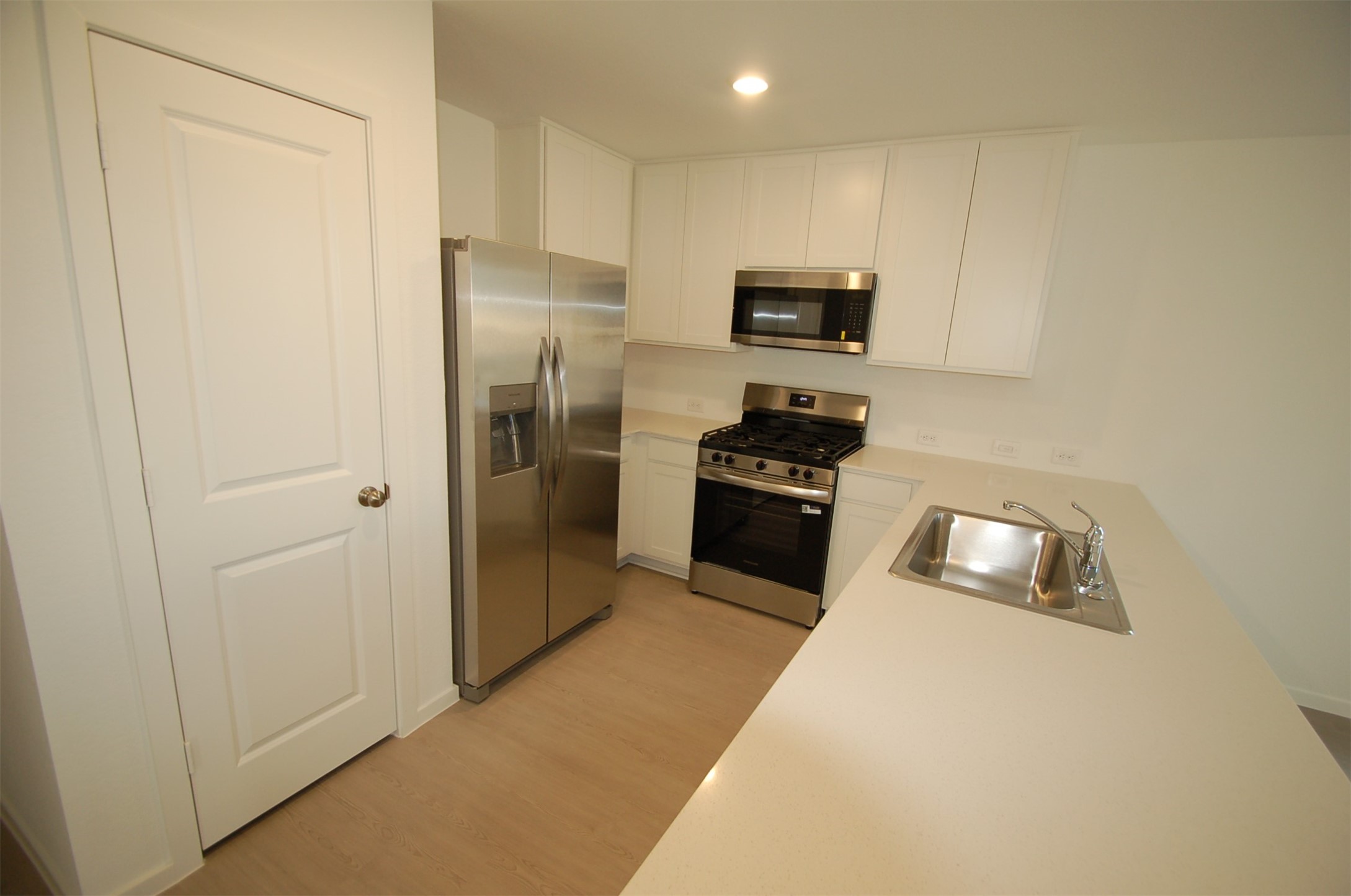 16130 Rustic Prairie Hockley, TX 77447 - Photo 4 of 21 a kitchen with white cabinets and stainless steel appliances
