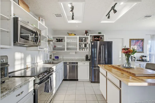 a view of an empty room with cabinet and a window
