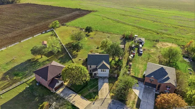 an aerial view of a residential houses with outdoor space