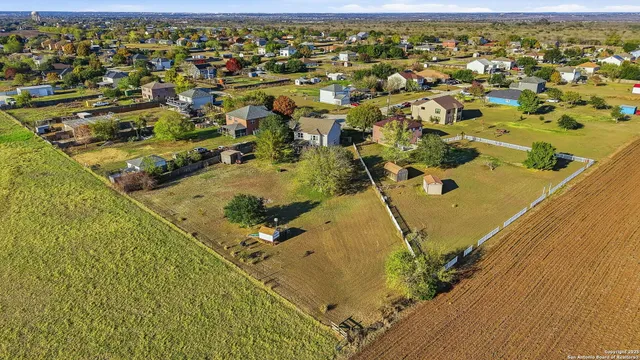 an aerial view of residential houses with outdoor space