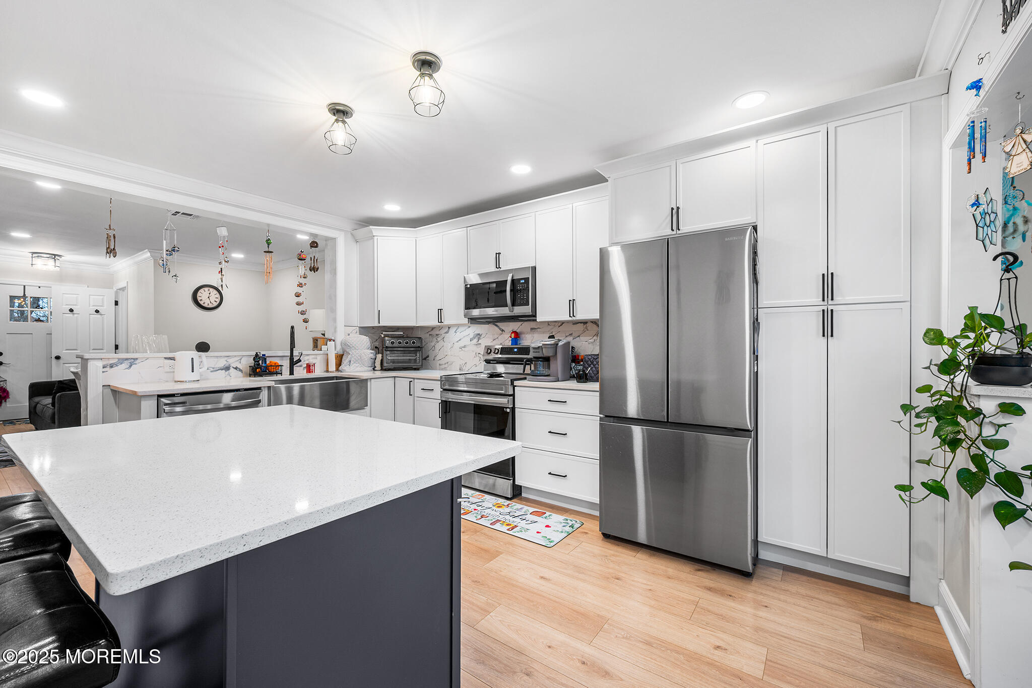 24 Calle De Elvira, Unit B Freehold, NJ 07728 - Photo 13 of 25 a kitchen with a refrigerator a oven a sink a counter space and wooden floor