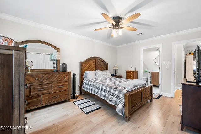 a bedroom with a bed and ceiling fan