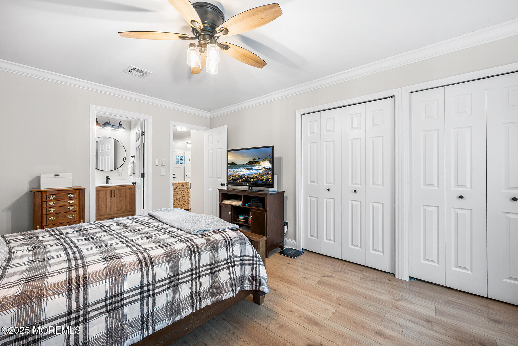 24 Calle De Elvira, Unit B Freehold, NJ 07728 - Photo 19 of 25 a bedroom with a bed and a chandelier