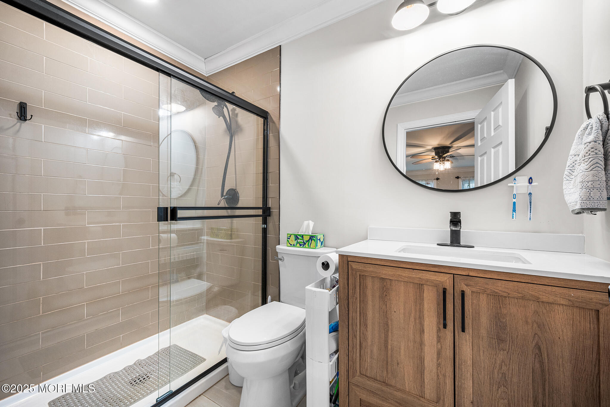 24 Calle De Elvira, Unit B Freehold, NJ 07728 - Photo 21 of 25 a bathroom with a sink a toilet and a mirror