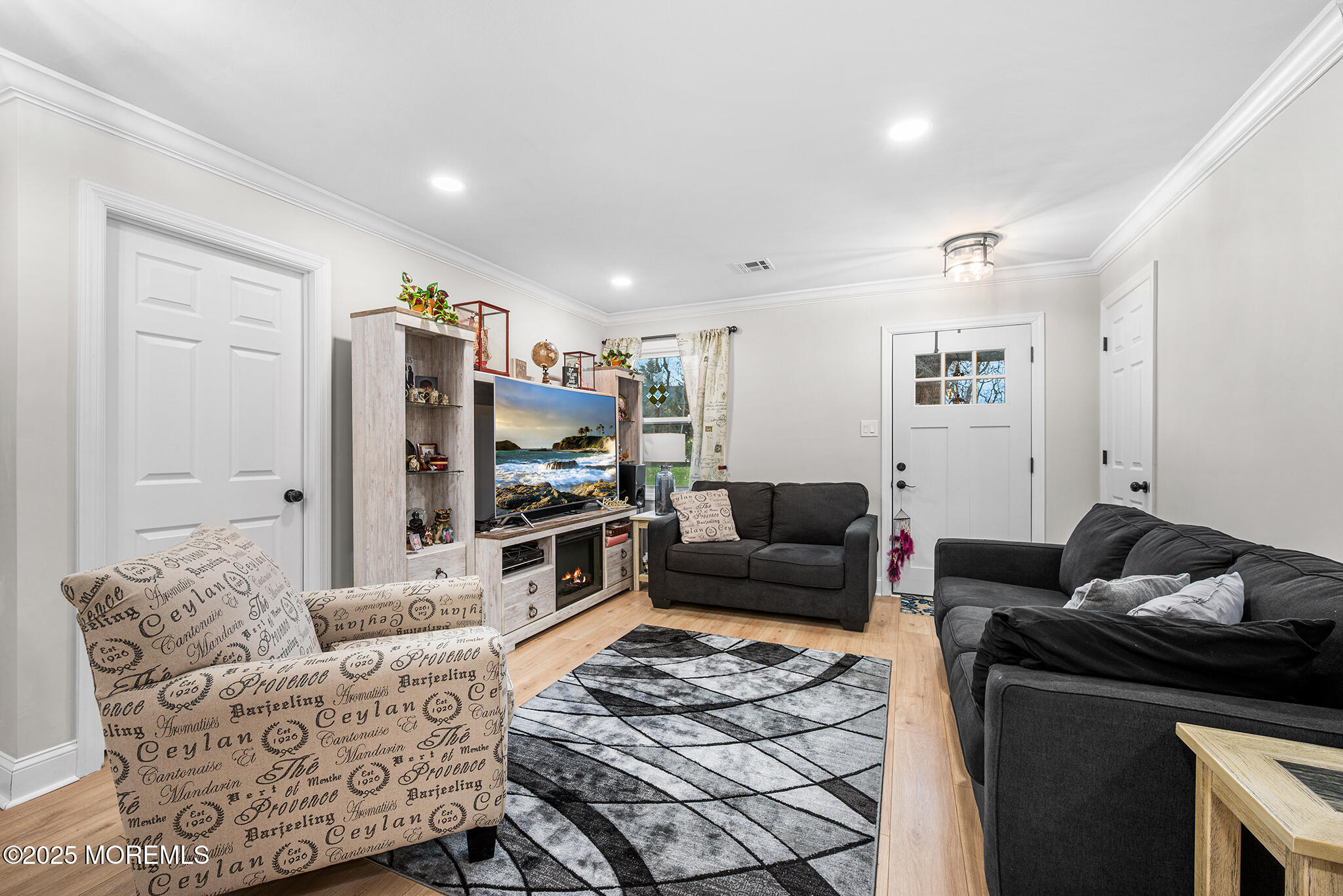 24 Calle De Elvira, Unit B Freehold, NJ 07728 - Photo 3 of 25 a living room with furniture and a flat screen tv